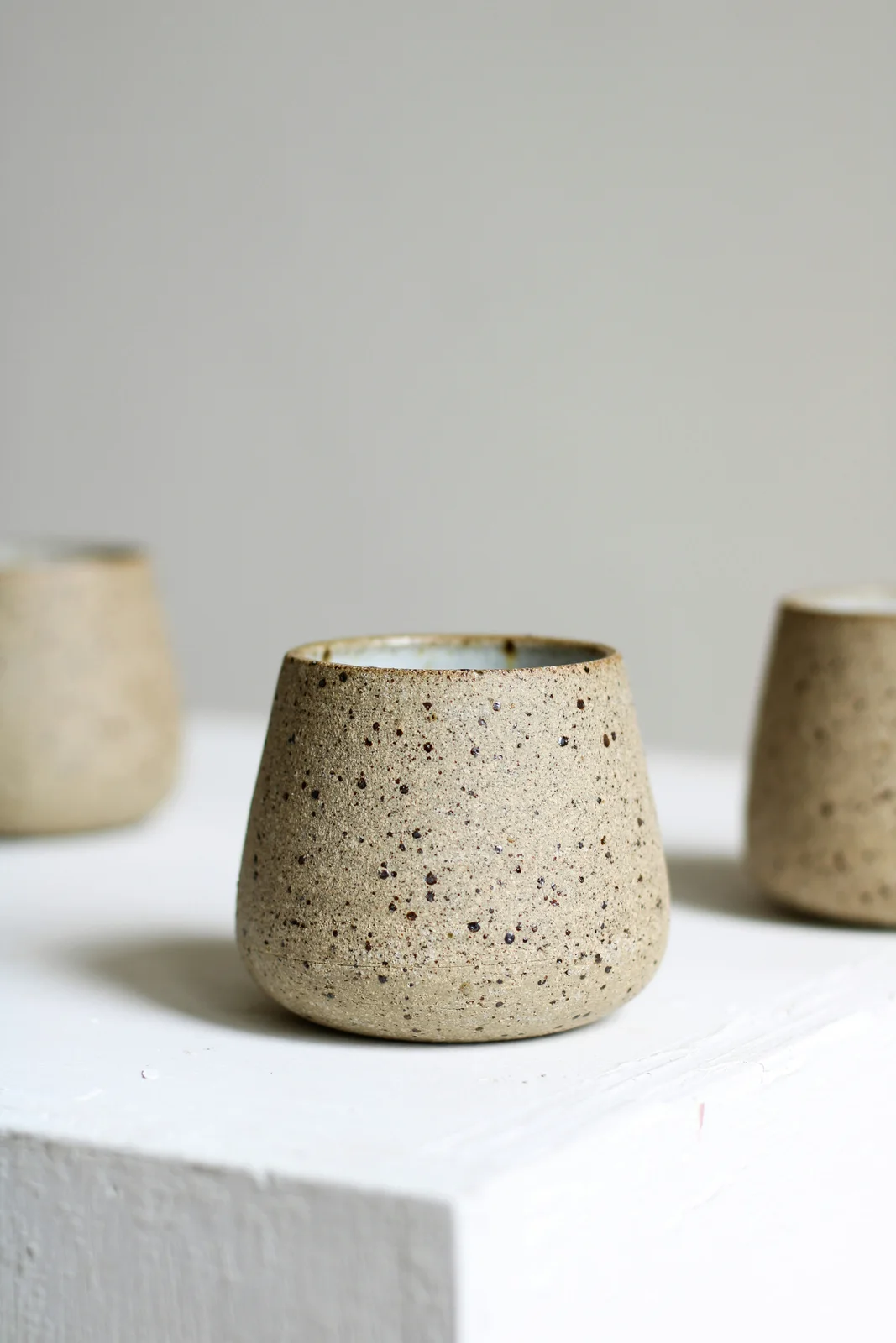 A speckled ceramic coffee cup