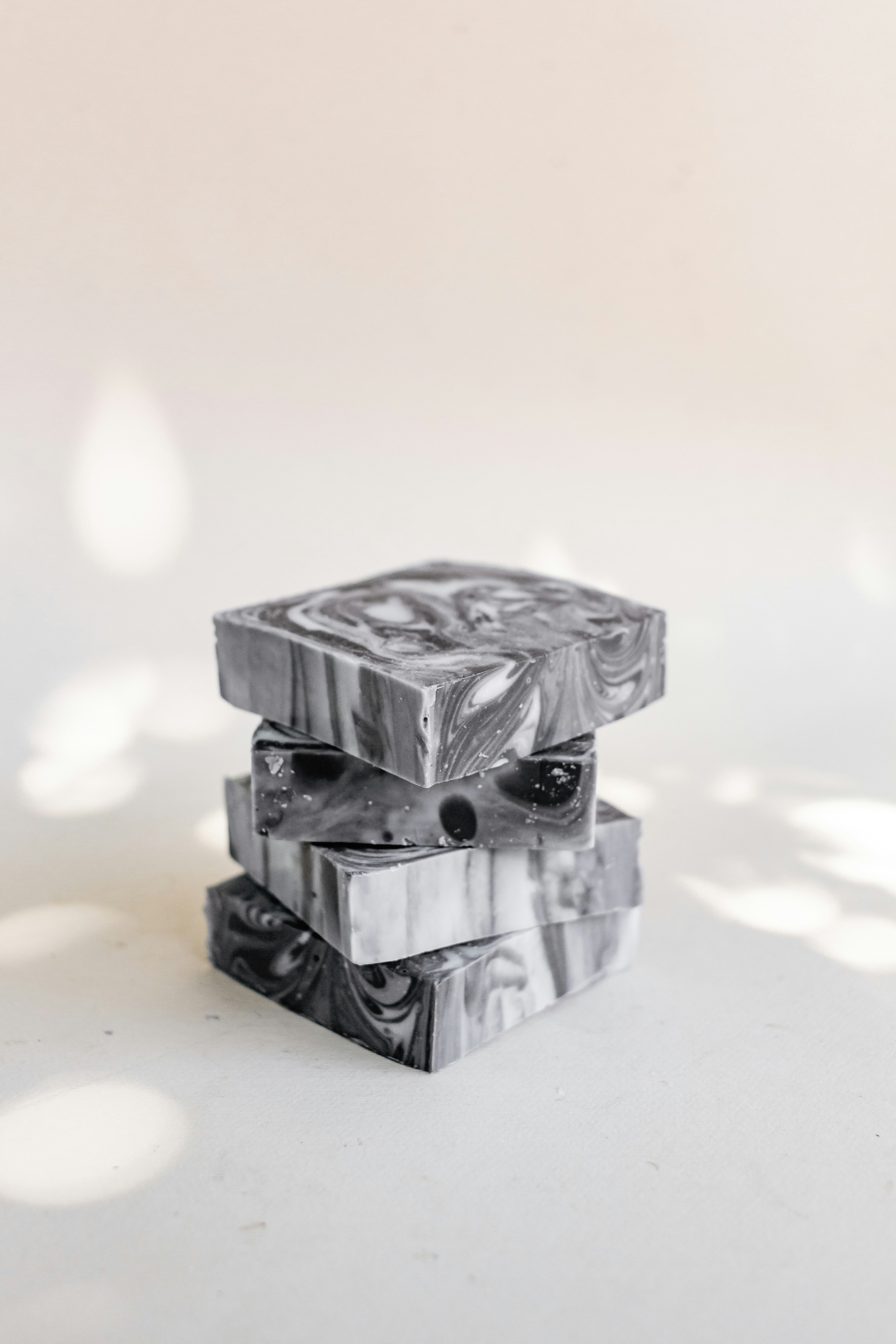 Charcoal-coloured soap bars with white marbled swirls