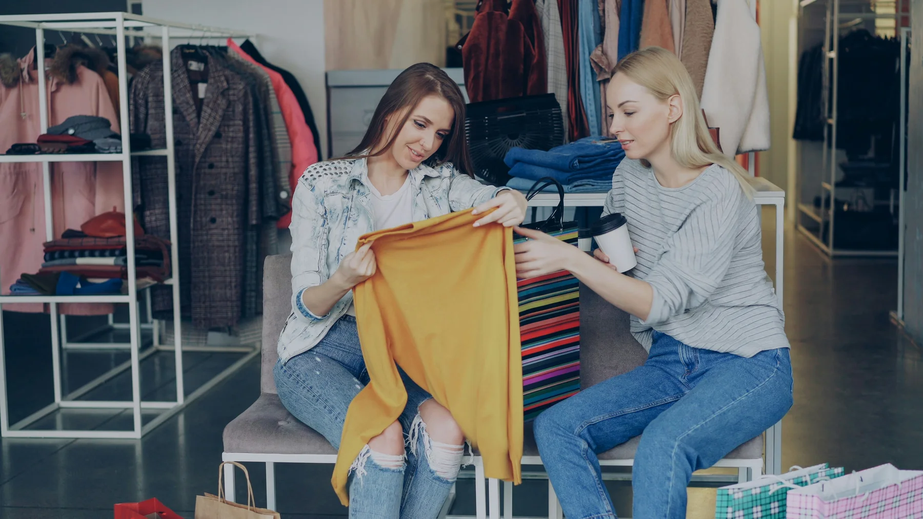 Two people looking at a garment together