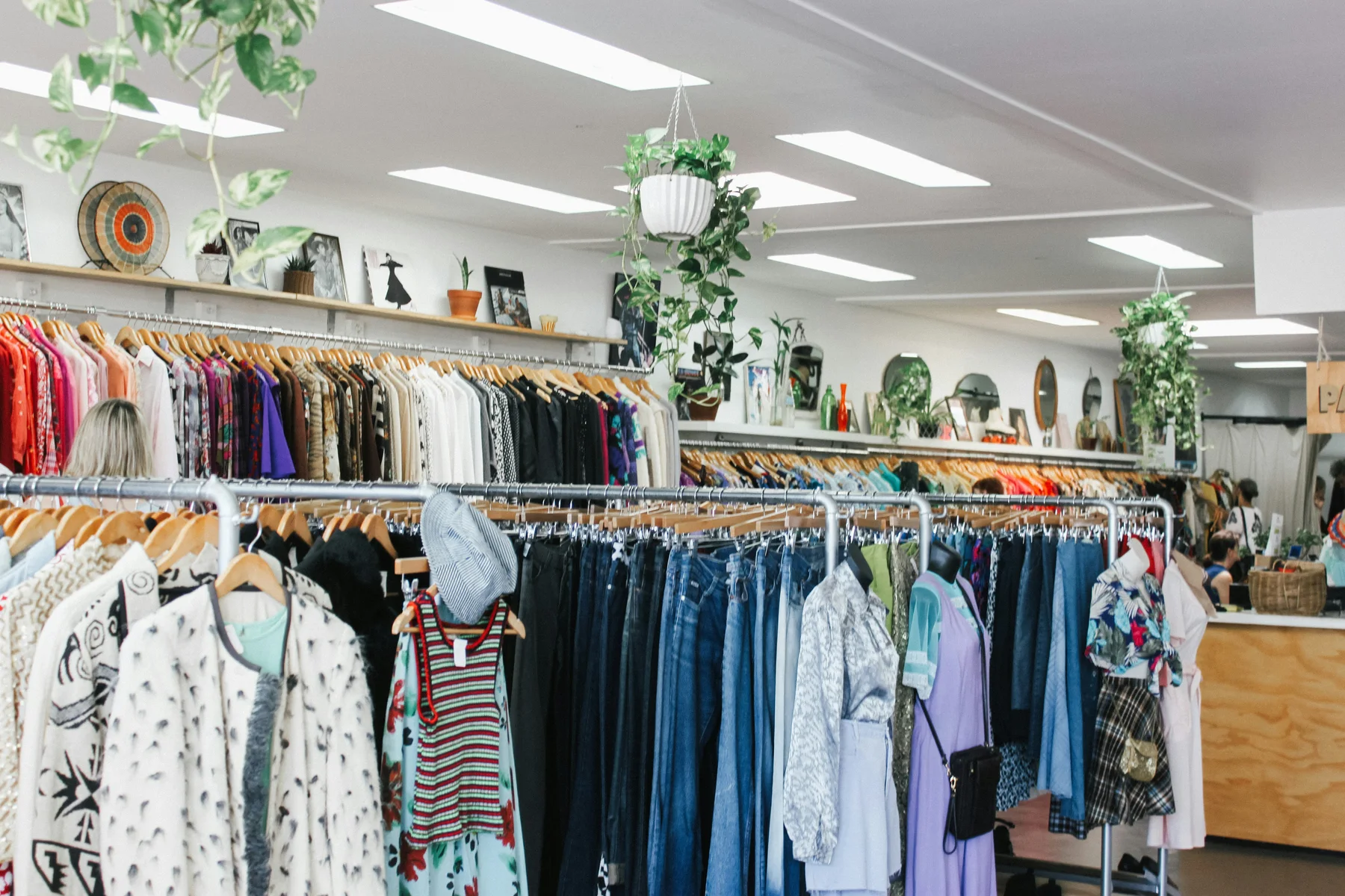 A bright thrift store filled with clothing rails