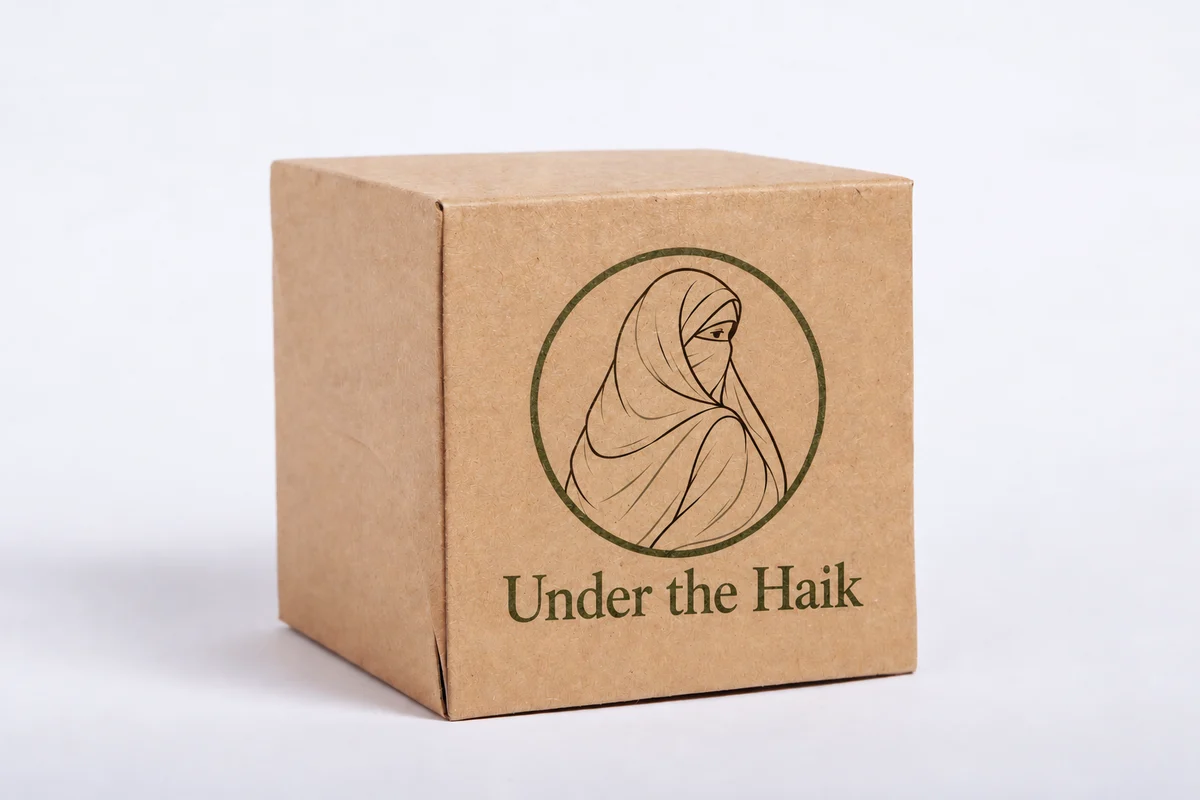 Kraft packaging box printed with the Under the Haik illustrated logo and brand name